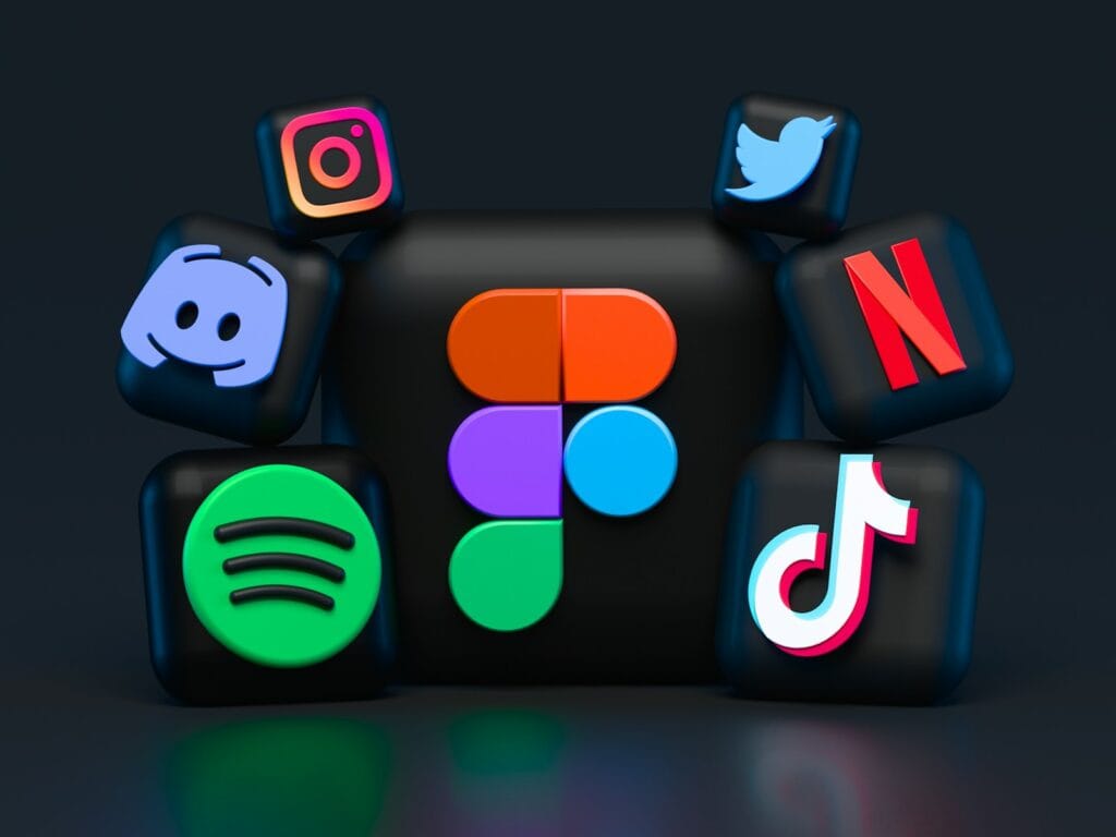 Social media icons floating with a black background and a slightly reflective surface below.